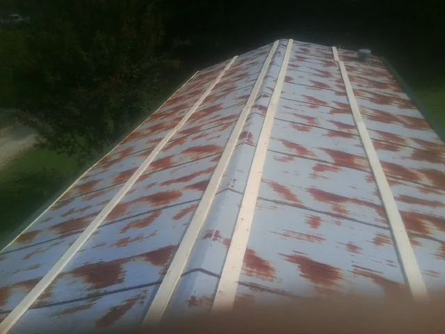 Rusted metal roof panels with new wood purlins before replacement — Storm Damage Roof Repair in Chickamauga by Roofing Brothers