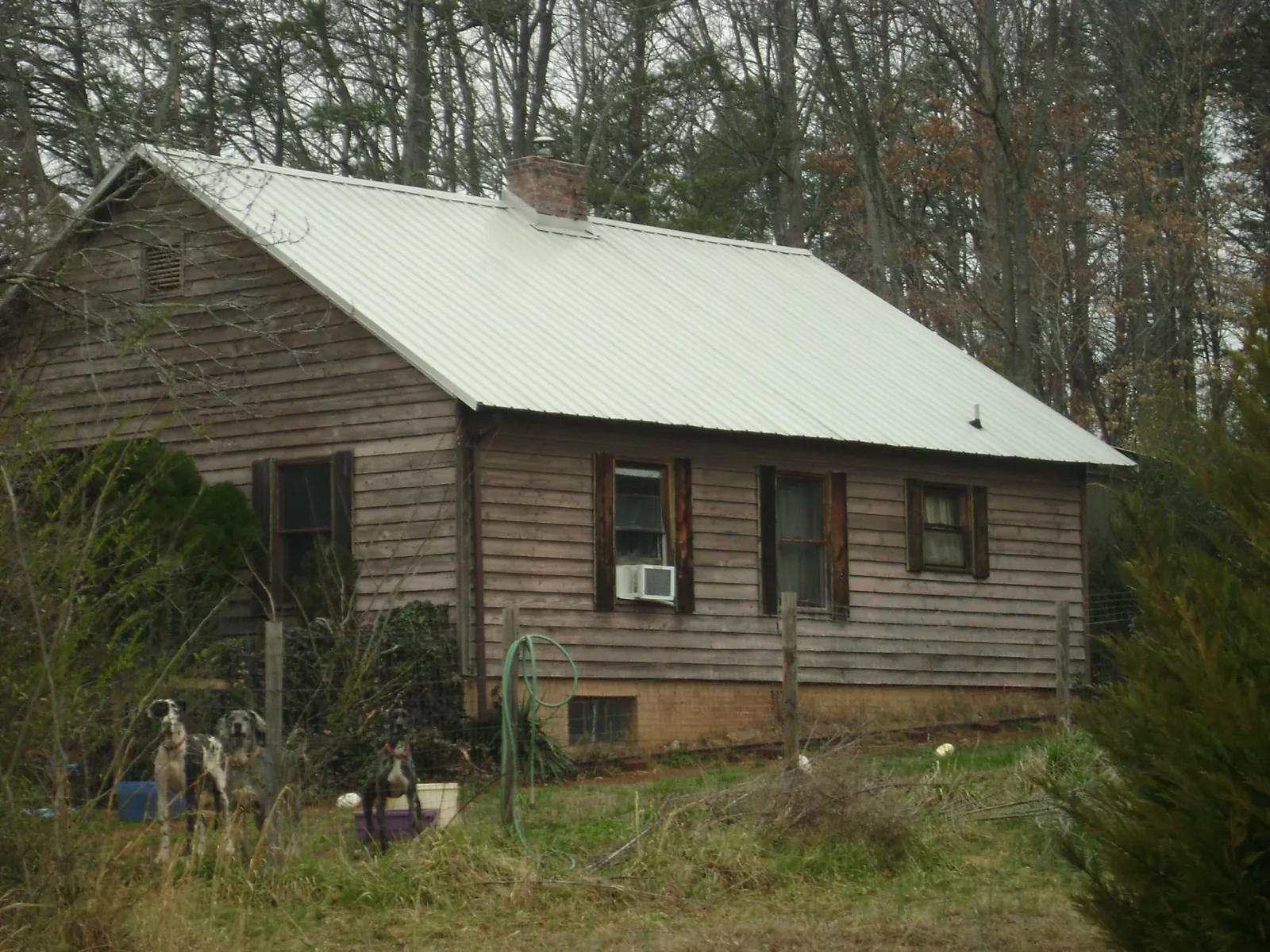 White metal roof on an old wood sided farmhouse, from a Asphalt Shingle Roof Repair job in Chickamauga